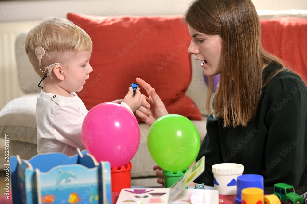 A Boy With A Hearing Aids And Cochlear Implants