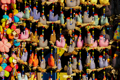 Curtain with several small cloth chickens, on a window in the historic city of Diamantina, Minas Gerais, Brazil