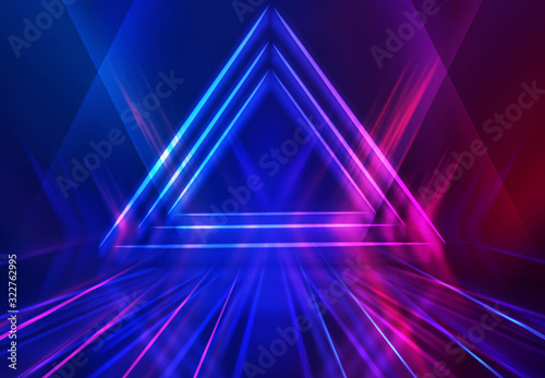 Dark abstract futuristic background. Geometric laser figure in the center of the stage. Neon blue-pink rays of light on a dark background