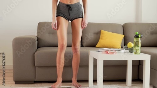 closeup without face, a skinny girl weighs in and weighs a record
