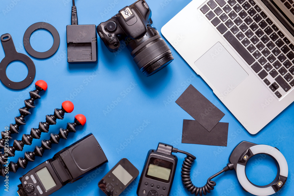 Frame made of modern photographer's equipment with laptop on color background Frame made of modern photographer's equipment with laptop on color background