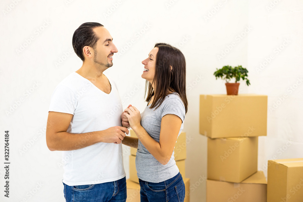 Thankful wife looks in her husband's eyes, happy to move into new house. Thankful wife looks in her husband's eyes, happy to move into new house.