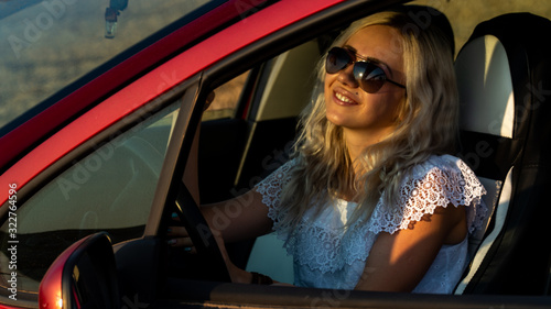 Beautiful sexy blonde woman, red car, field © Oleksandr