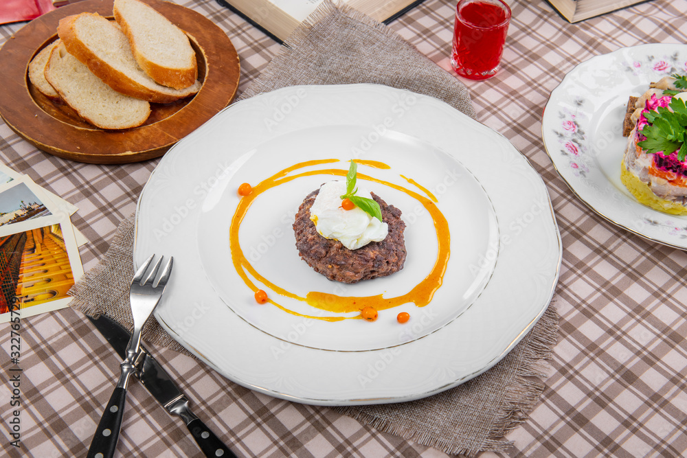 steak with poached egg in a brown cage