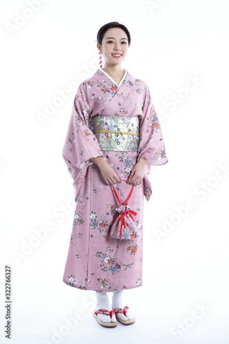 Fotografie, Tablou Young woman wearing Japanese kimono, isolated on white background