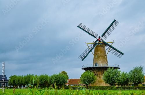 Goes, the netherlands, august 2019. In the countryside of the zealand region, a perfectly preserved and functioning windmill. Typical postcard landscape of the Dutch countryside.