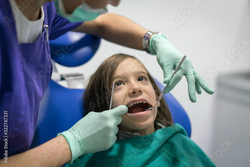 Young Smiling Boy Posing Before Regular Dental Check Up in Clinic