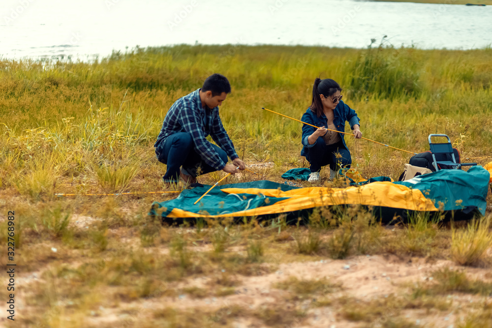 A group of friends traveling and camping near lake and mountain back. A group of friends traveling and camping near lake and mountain back.
