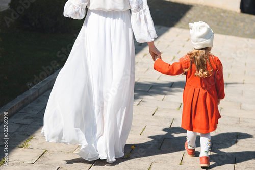 bride and girl holding hands