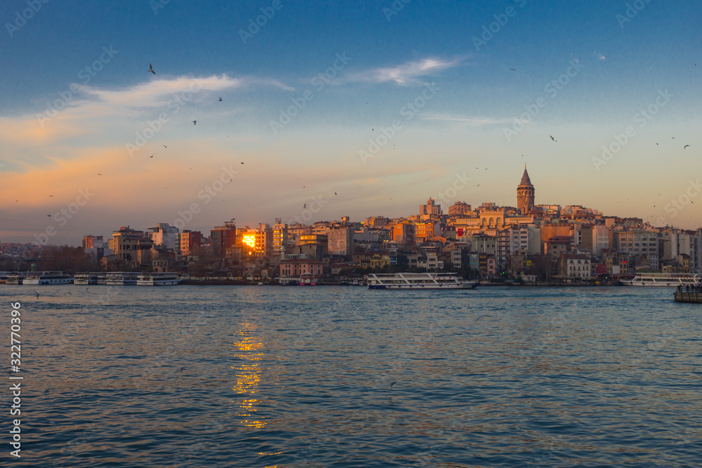 Bosphorus in winter on sunset with seagulls over the water