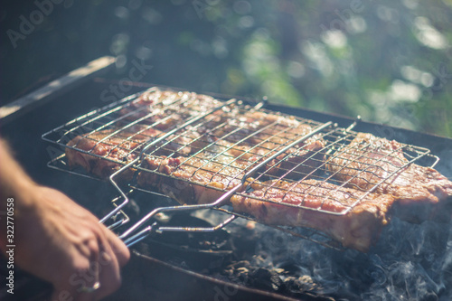 A man cooking barbecue on a grill rack
