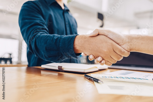 Business shaking hands, finishing up meeting. Successful businessmen handshaking after good deal.