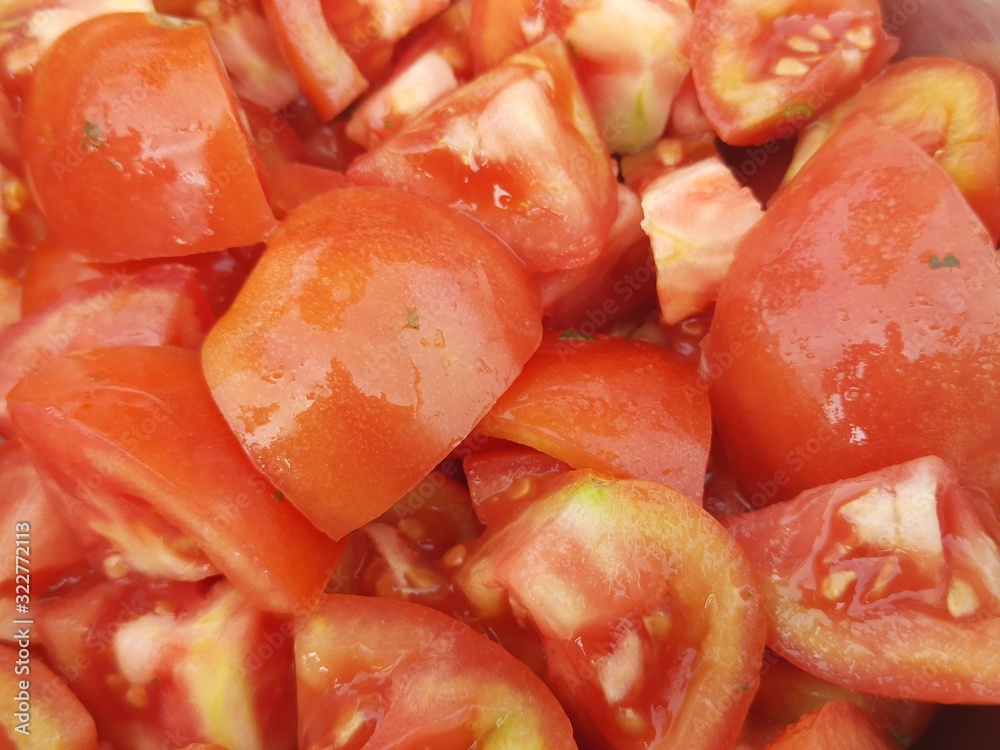 Cutting tomato Ready for cooking. A beautiful picture of red tomato. Most popular vegetable of all over world.Tomato Salad. Red background. Cutting tomato Ready for cooking. A beautiful picture of red tomato. Most popular vegetable of all over world.Tomato Salad. Red background.