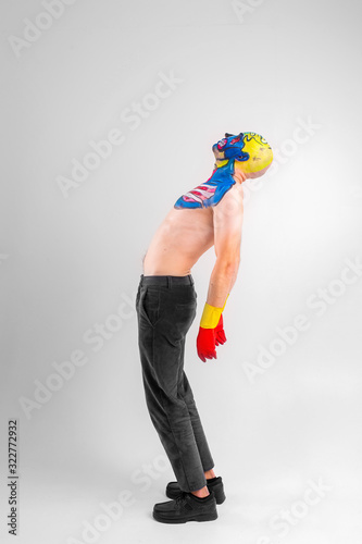 Quaint man with a painted head and shoullder in gloves jumps isolated on white background