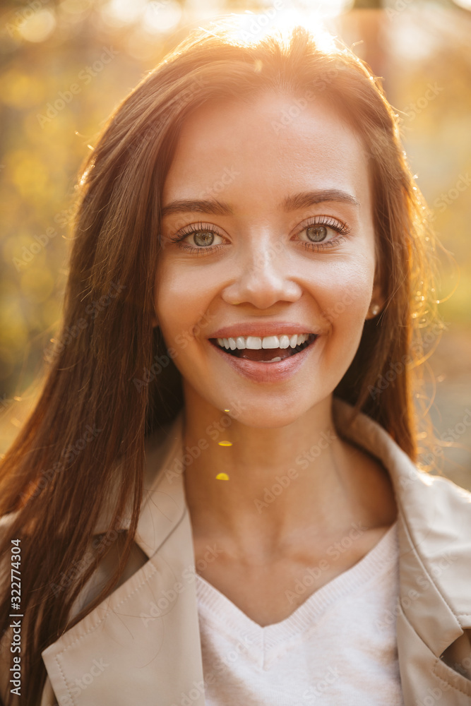 Close up of a beautiful smiling young woman walking Close up of a beautiful smiling young woman walking