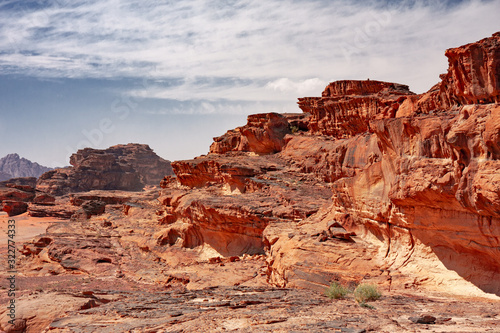 Panoramic view of rocky mountains and red sand in the Jordanian desert of Wadi Rum. © serghi8