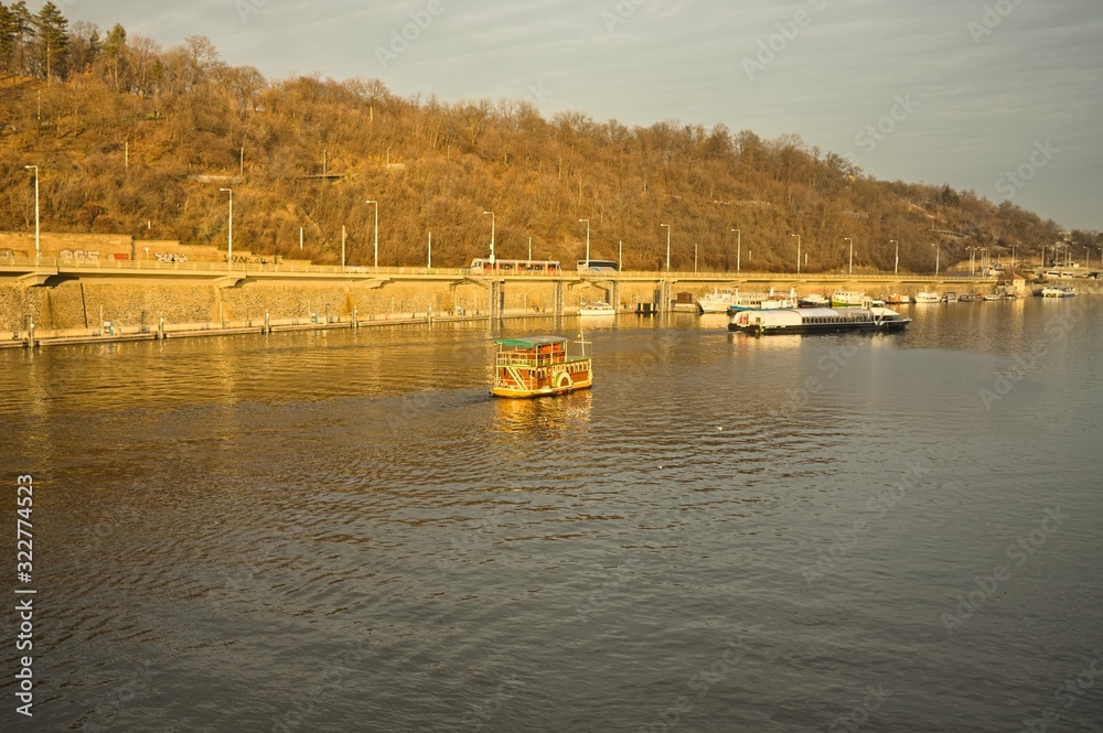 A vintage boat is sailing on the Vltava river (Prague, Czech Republic, Europe)