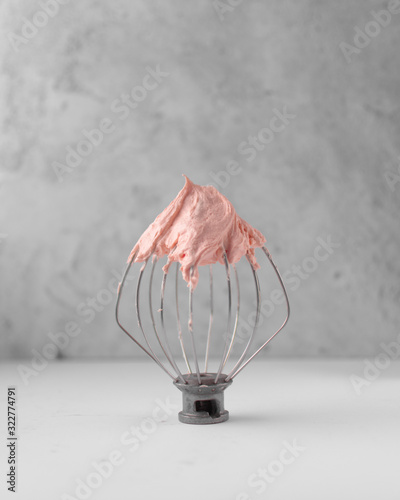 Peach american buttercream on a whisk attachment