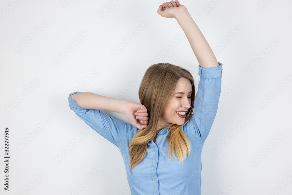 young beatuiful jolly blond woman standing on isolated white background smiling, holding her hands up, dancing happy, pure beauty concept young beatuiful jolly blond woman standing on isolated white background smiling, holding her hands up, dancing happy, pure beauty concept