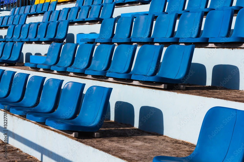 Fototapeta premium Empty old blue seats in the blue in stadium.