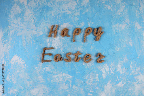 Happy Easter rope typography on the blue textured background. Greeting card.