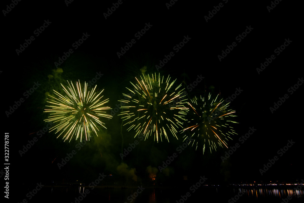 Colored firework background with free space for text. Colorful fireworks at night light up the sky.