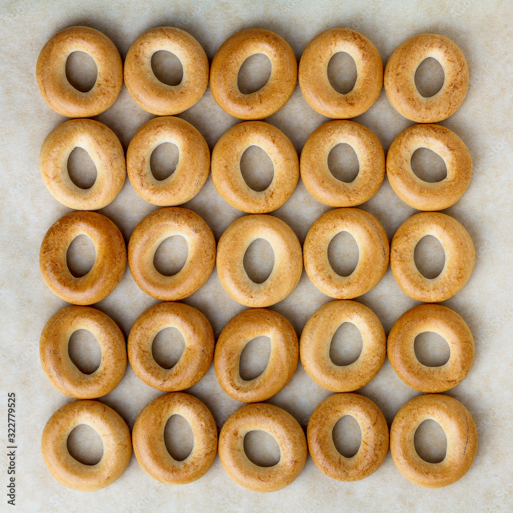 Drying or bagels on baking parchment, flat lay. Drying or bagels on baking parchment, flat lay.