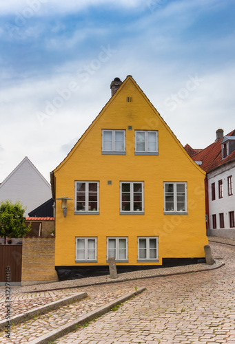 Yellow house in the cobblestoned street of Haderslev, Denmark