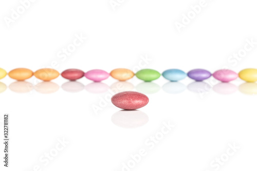 Lot of whole sweet colourful candy red in focus isolated on white background