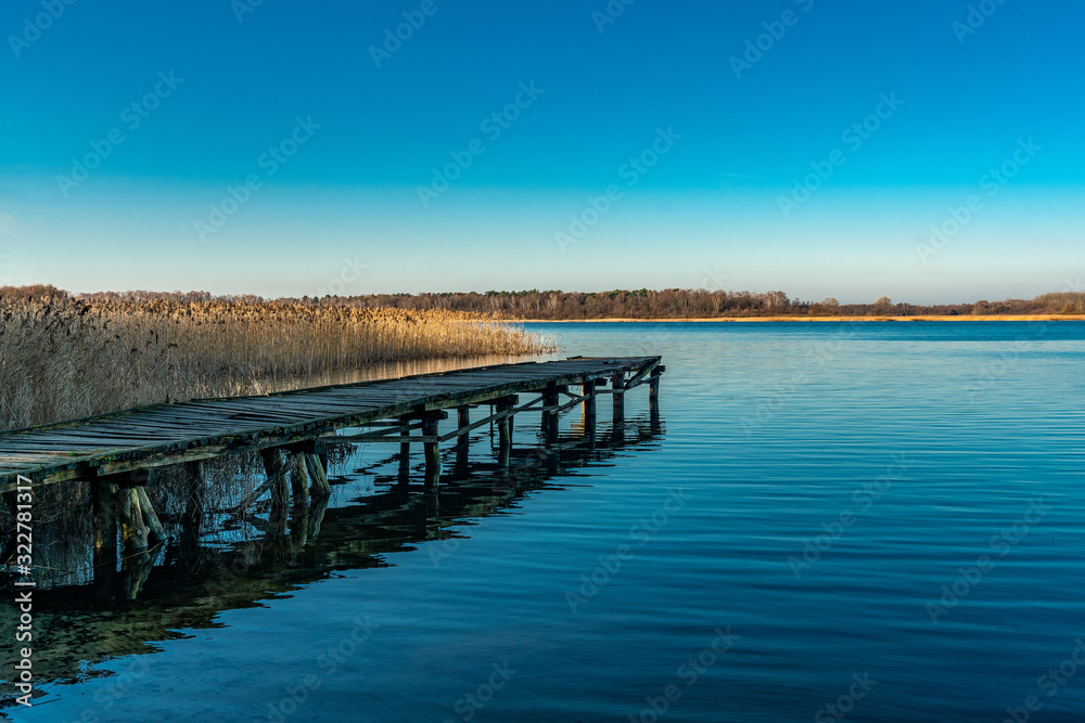 Old wooden landing stage at a tranquil lake