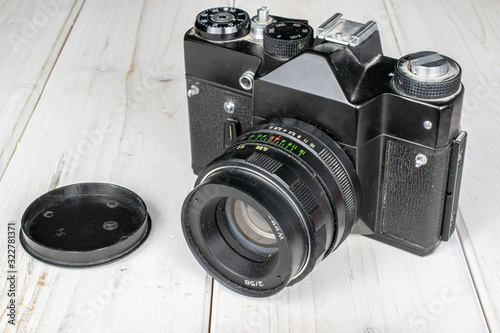 Group of one whole one piece of vintage camera on white wood photo
