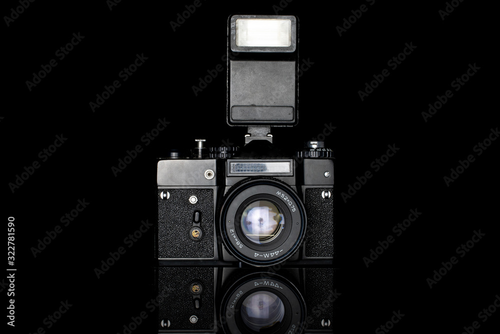 One whole camera with flash isolated on black glass - obrazy, fototapety, plakaty 