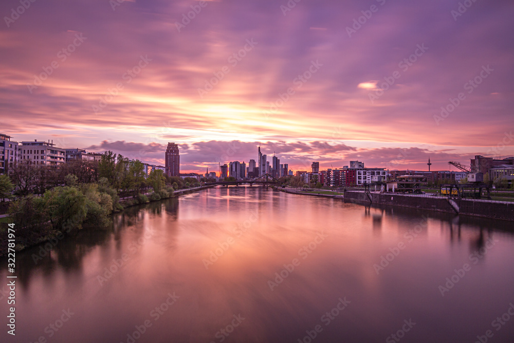 Beautiful sunset over Frankfurt Skyline, reflection on main river