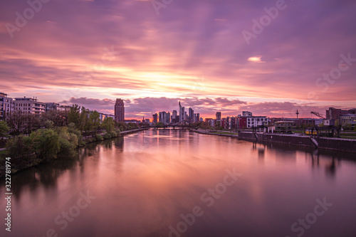 Beautiful sunset over Frankfurt Skyline, reflection on main river