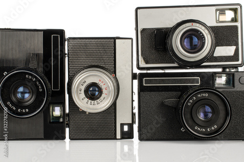 Group of four whole vintage camera isolated on white background photo