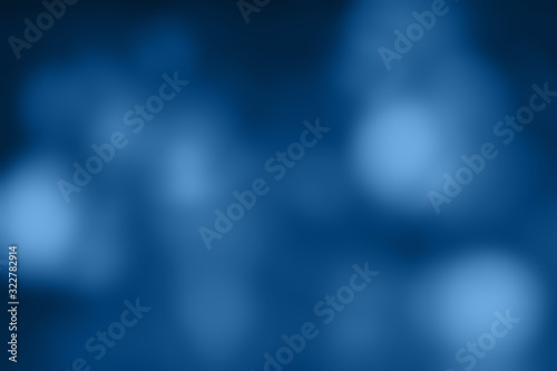 Different shades of classic blue blurry lights. Dark blurred background in trend colors