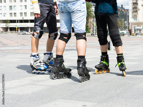Close-up view of male legs in roller skates. Figure skating on roller skates.