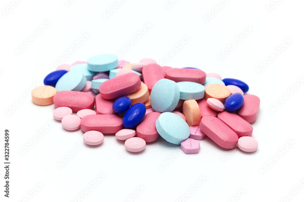 Many colorful medical pills on white background. Selective focus. Many colorful medical pills on white background. Selective focus.