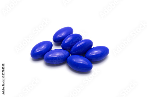 Medical pills with blue color on white background.