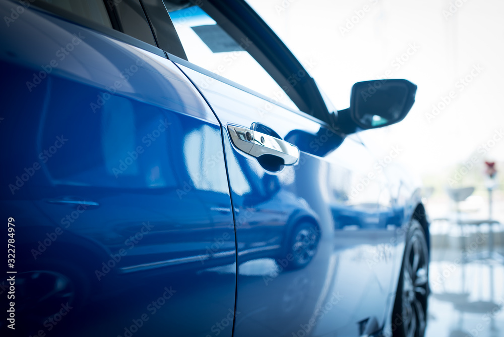 Close up photo of New blue car door. Concept for car rental.,New cars available for sale, parked in the showroom.