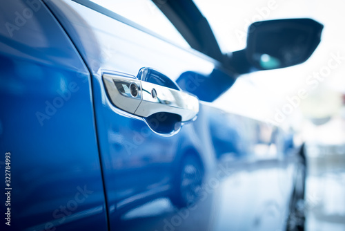 Close up photo of New blue car door. Concept for car rental.,New cars available for sale, parked in the showroom. photo