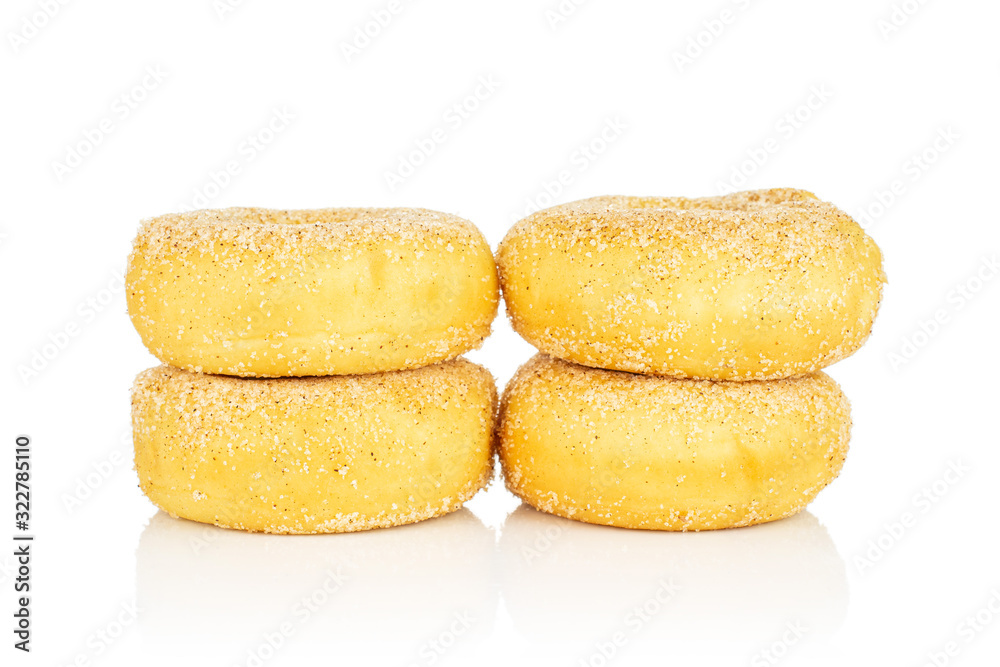 Group of four whole sweet golden mini cinnamon donut in two columns isolated on white background Group of four whole sweet golden mini cinnamon donut in two columns isolated on white background