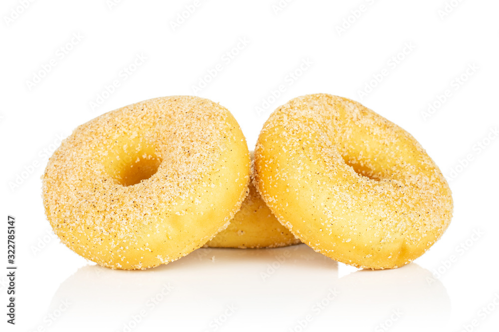 Group of three whole sweet golden mini cinnamon donut isolated on white background Group of three whole sweet golden mini cinnamon donut isolated on white background