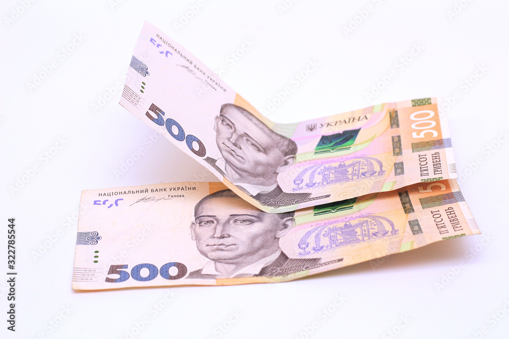 Two new banknotes in denominations of 500 Ukrainian hryvnias isolated on a white background with shadow. European money exchange. Ukraine currency Two new banknotes in denominations of 500 Ukrainian hryvnias isolated on a white background with shadow. European money exchange. Ukraine currency