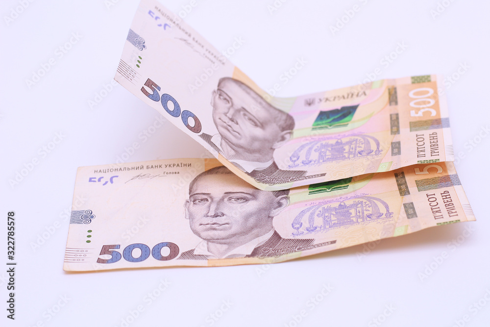 Two new banknotes in denominations of 500 Ukrainian hryvnias isolated on a white background with shadow. European money exchange. Ukraine currency Two new banknotes in denominations of 500 Ukrainian hryvnias isolated on a white background with shadow. European money exchange. Ukraine currency
