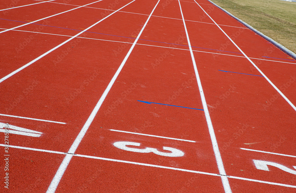 Red running tracks on the sporting venue center. Striped tracks for competing sports.