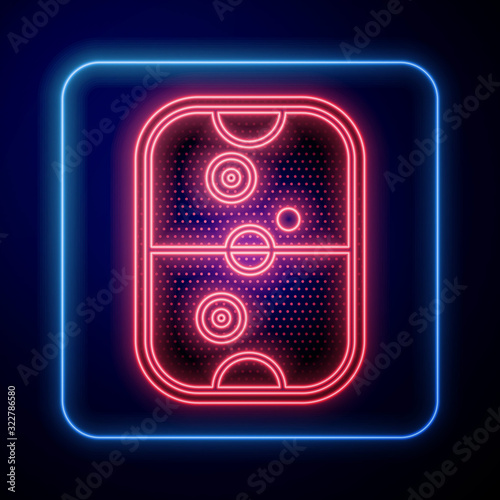 Glowing neon Air hockey table icon isolated on blue background.  Vector Illustration