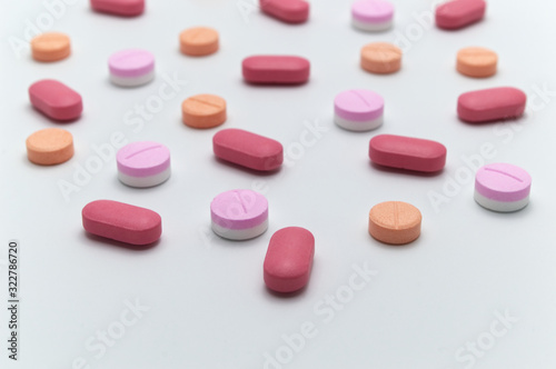 Different colorful drugs or medicine pills tablet supplements for the treatment and health care on a white background and Selective focus.