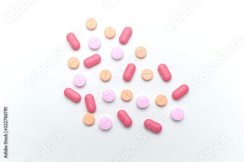 Different colorful drugs or medicine pills tablet supplements for the treatment and health care on a white background. Top view.
