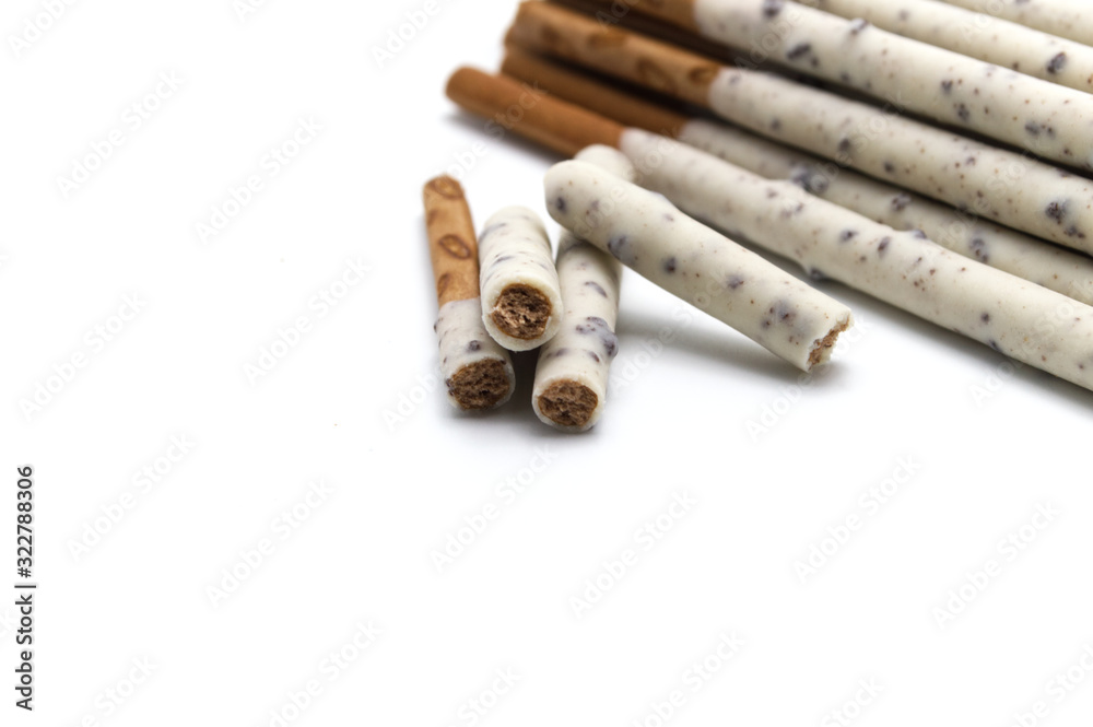 Chocolate biscuit stick coated with milk flavour confectionery and crushed cookies and cream taste isolated on white background. Chocolate biscuit stick coated with milk flavour confectionery and crushed cookies and cream taste isolated on white background.